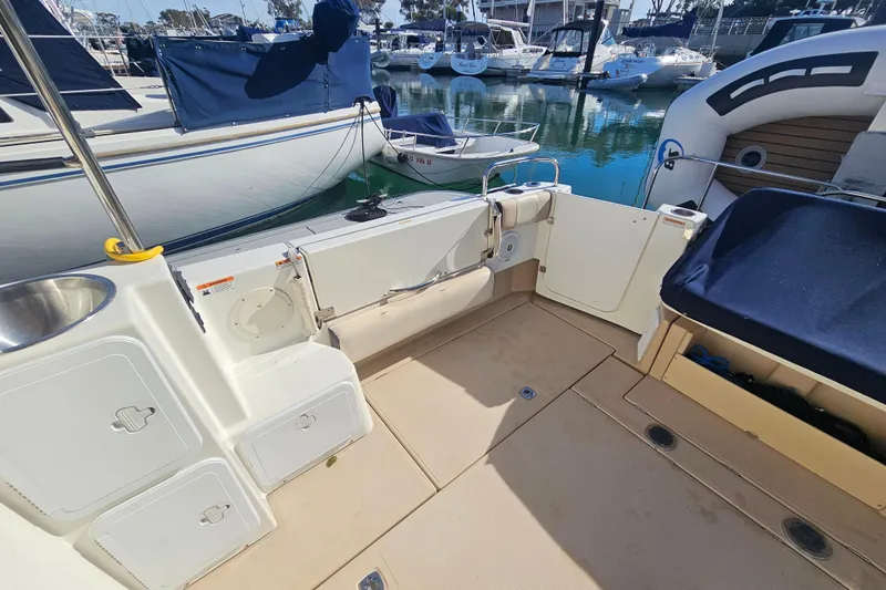 Tuva- B - Lu Yacht Photos Pics 2015 Cutwater 30 Command Bridge boat interior, featuring deck and storage compartments at marina.