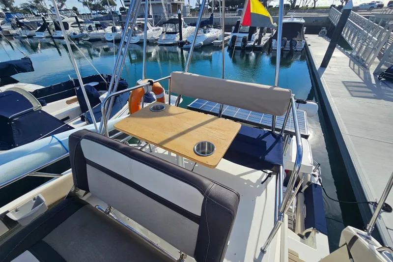 Tuva- B - Lu Yacht Photos Pics 2015 Cutwater 30 Command Bridge at marina, featuring seating and table on deck.