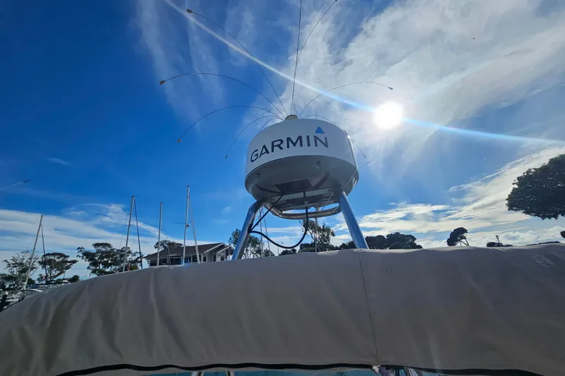 Tuva- B - Lu Yacht Photos Pics Cutwater 30 Command Bridge 2015 with Garmin radar under a bright blue sky.