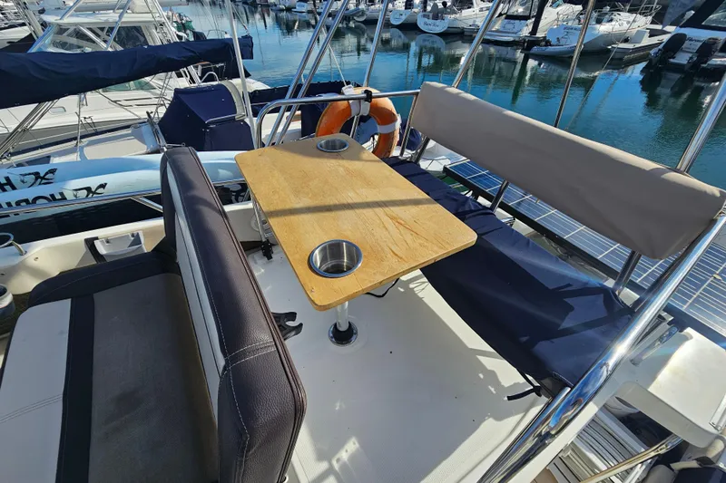 Tuva- B - Lu Yacht Photos Pics 2015 Cutwater 30 Command Bridge boat interior with seating and table at marina.