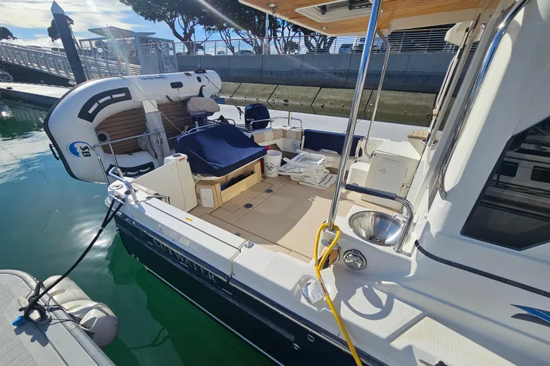 Tuva- B - Lu Yacht Photos Pics 2015 Cutwater 30 Command Bridge docked, featuring spacious deck and inflatable dinghy.