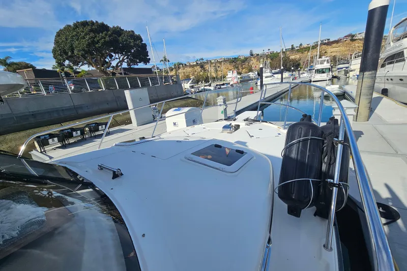 Tuva- B - Lu Yacht Photos Pics 2015 Cutwater 30 Command Bridge docked at marina, clear sky, calm water.