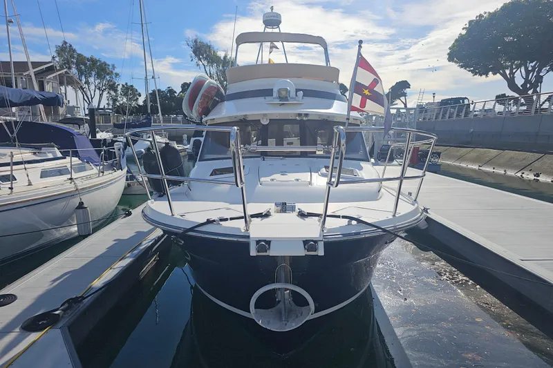 Tuva- B - Lu Yacht Photos Pics 2015 Cutwater 30 Command Bridge docked at marina, front view with flag.