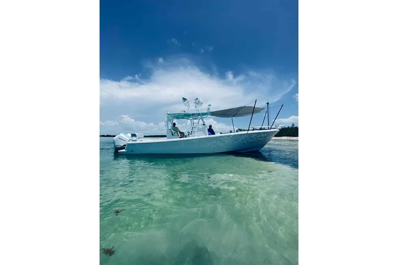 El Viaje Yacht Photos Pics 2023 Andros Offshore 32 boat on clear turquoise water under a bright blue sky.
