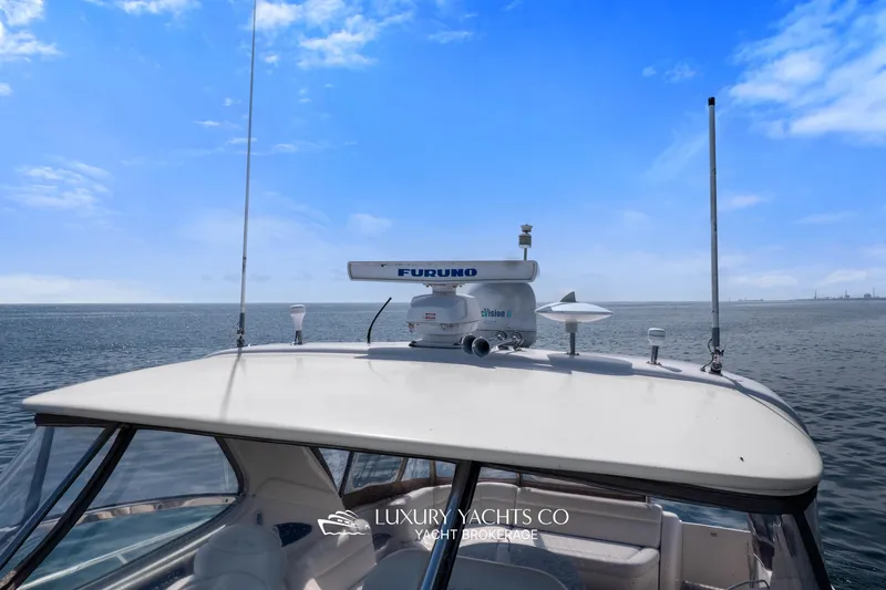  Yacht Photos Pics 1999 Sea Ray Sundancer 540 yacht with radar equipment, cruising on open water under blue skies.