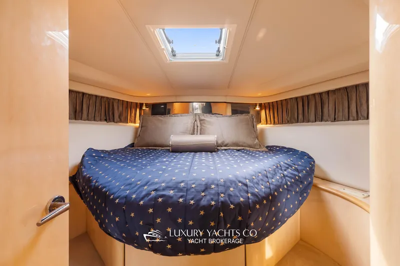  Yacht Photos Pics Luxurious cabin interior of 1999 Sea Ray Sundancer 540 yacht with star-patterned bedding.