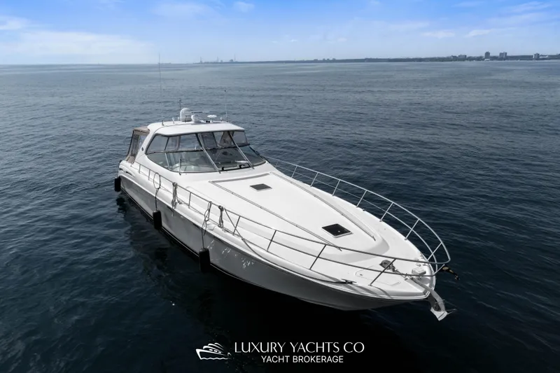  Yacht Photos Pics 1999 Sea Ray Sundancer 540 yacht on calm ocean waters, clear sky background.