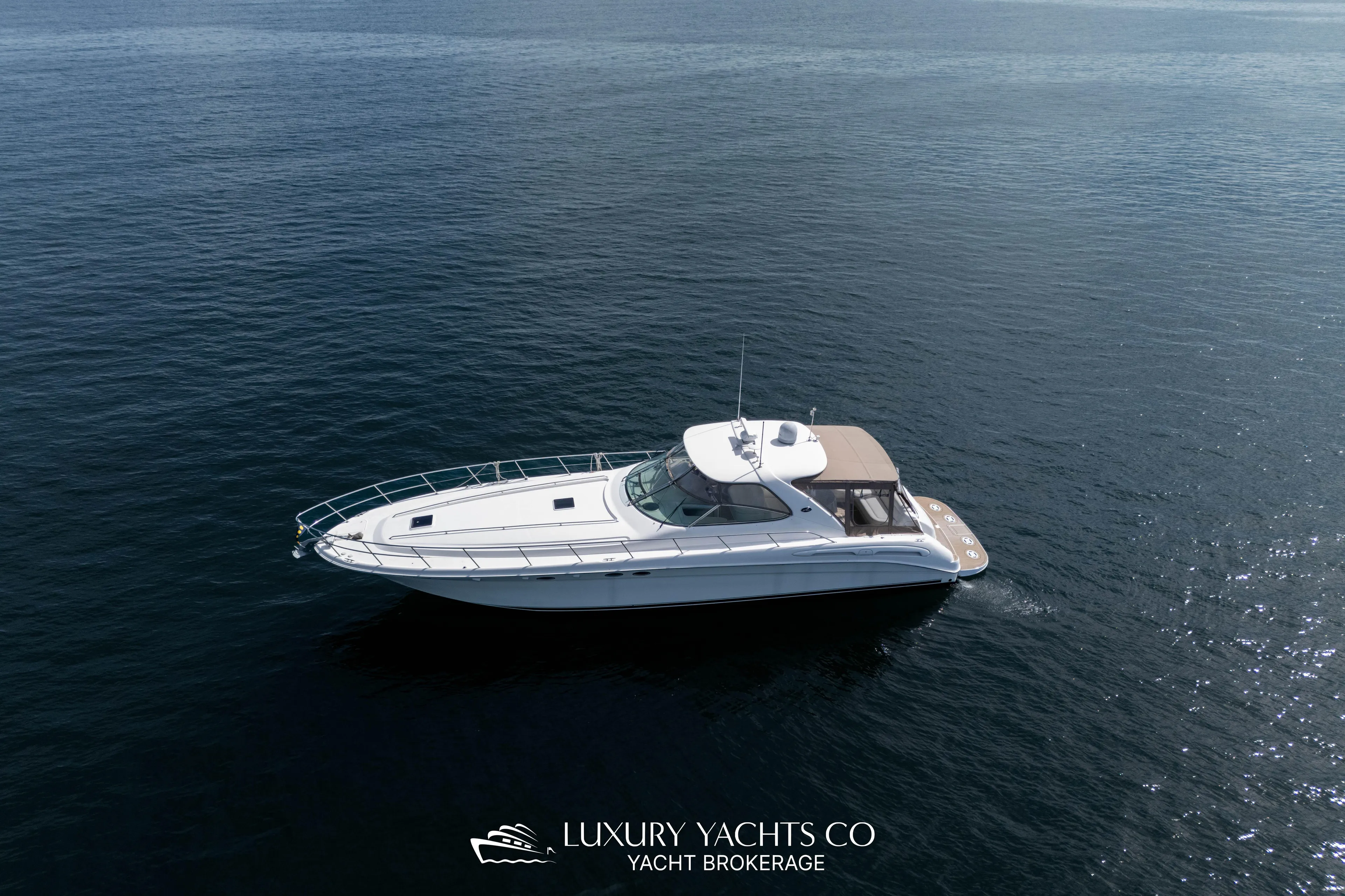  Yacht Photos Pics 1999 Sea Ray Sundancer 540 yacht cruising on open water, aerial view.