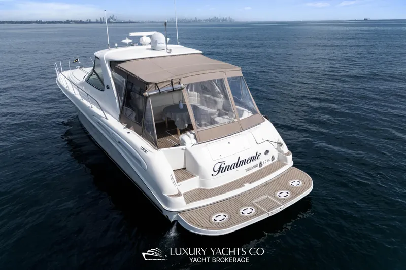  Yacht Photos Pics 1999 Sea Ray Sundancer 540 yacht on open water, rear view, Toronto skyline in background.