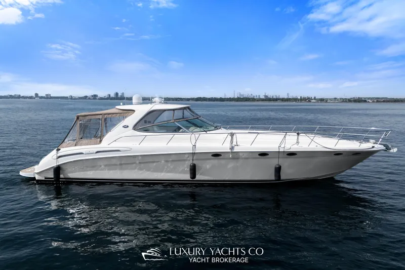  Yacht Photos Pics 1999 Sea Ray Sundancer 540 yacht on calm water under a clear blue sky.