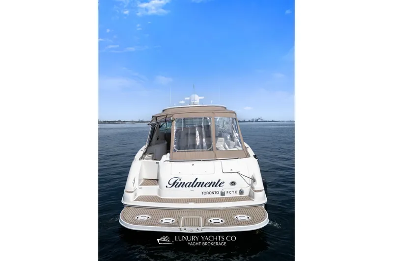  Yacht Photos Pics 1999 Sea Ray Sundancer 540 yacht on calm water, clear sky background.
