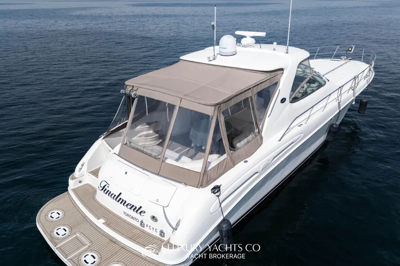  Yacht Photos Pics 1999 Sea Ray Sundancer 540 yacht on calm water, featuring a beige canopy.