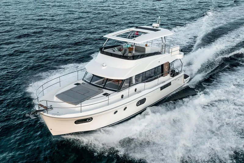  Yacht Photos Pics 2026 Beneteau Swift Trawler 48 cruising on open water, showcasing sleek design and performance.