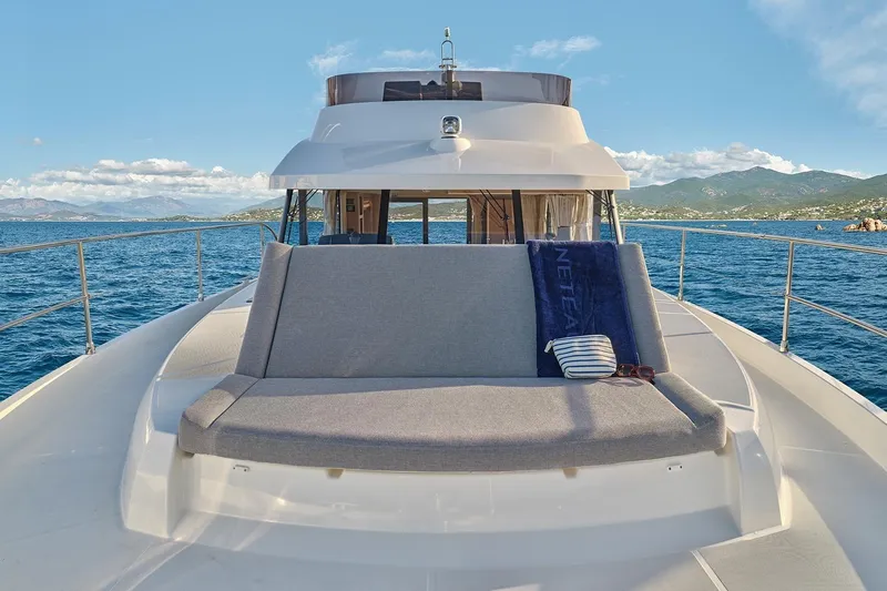  Yacht Photos Pics 2026 Beneteau Swift Trawler 48 on open water, featuring a spacious deck with seating.