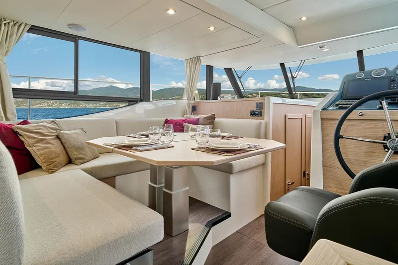  Yacht Photos Pics Interior of 2026 Beneteau Swift Trawler 48 with elegant dining area and helm.