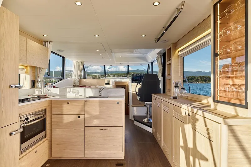  Yacht Photos Pics Luxurious interior of 2026 Beneteau Swift Trawler 48 with modern kitchen and scenic views.