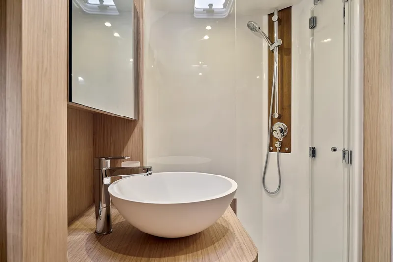  Yacht Photos Pics Modern bathroom in 2026 Beneteau Swift Trawler 48 with sleek sink and shower.