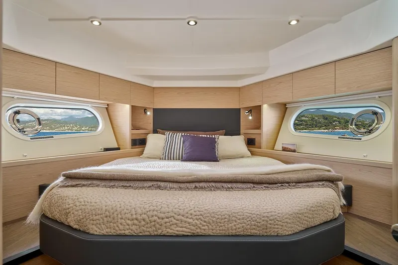  Yacht Photos Pics Luxurious bedroom interior of 2026 Beneteau Swift Trawler 48 with scenic window views.
