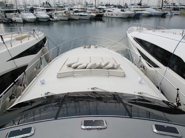 Mr Chic Yacht Photos Pics Luxury yacht Riva 84 Cantata 2001 docked among other boats in a marina.