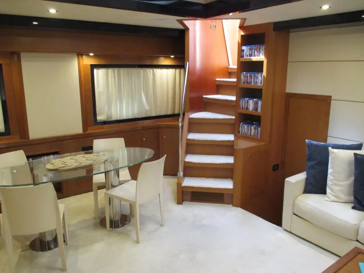 Mr Chic Yacht Photos Pics Luxurious interior of 2001 Riva 84 Cantata yacht with modern dining area and staircase.
