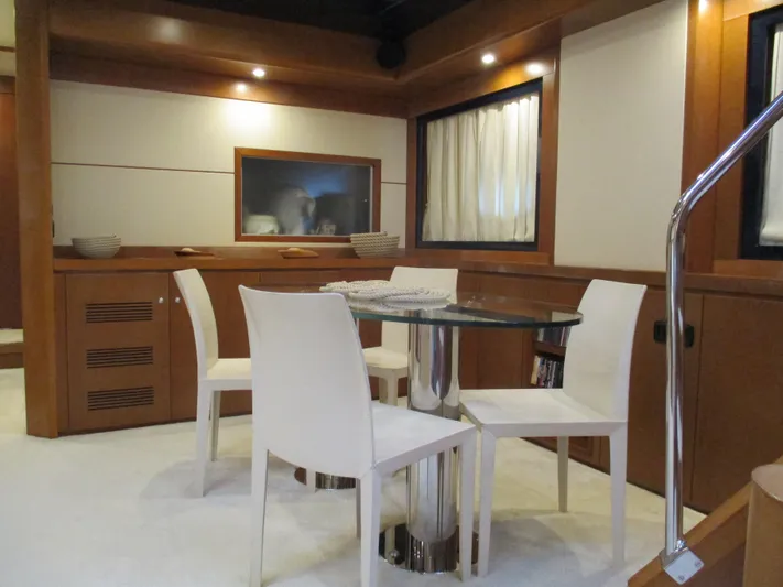 Mr Chic Yacht Photos Pics Luxurious interior of 2001 Riva 84 Cantata yacht with modern dining area.