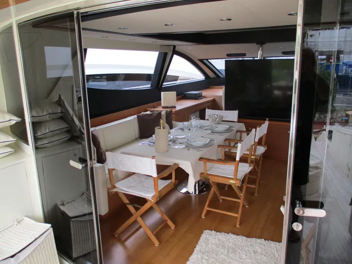 Mr Chic Yacht Photos Pics Luxurious interior of 2001 Riva 84 Cantata yacht with elegant dining setup.
