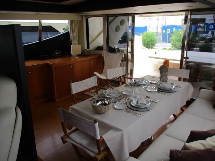Mr Chic Yacht Photos Pics Luxurious dining area on 2001 Riva 84 Cantata yacht, elegantly set table with modern decor.