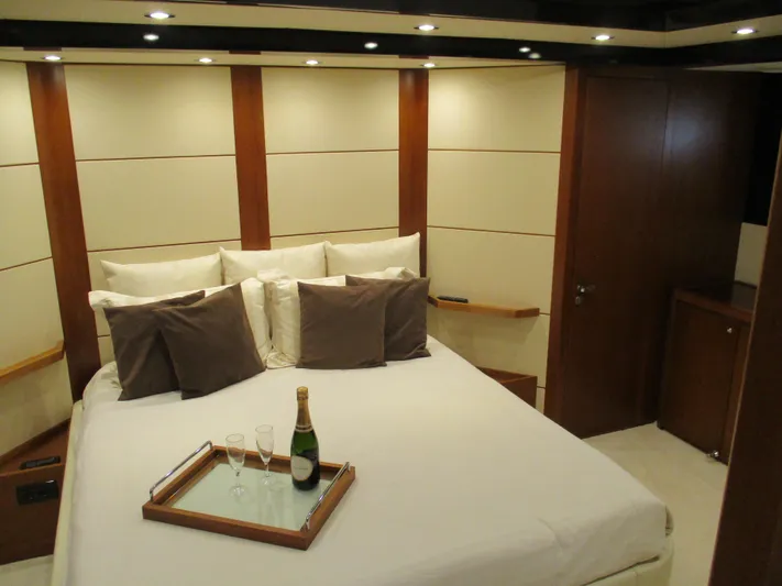 Mr Chic Yacht Photos Pics Luxurious bedroom interior of 2001 Riva 84 Cantata yacht with champagne on bed.