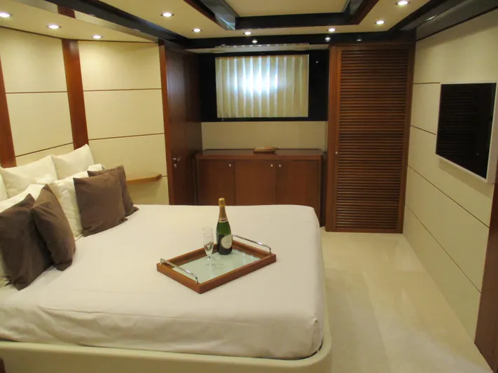 Mr Chic Yacht Photos Pics Luxurious bedroom interior of 2001 Riva 84 Cantata yacht with champagne on bed.