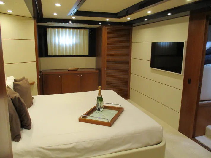 Mr Chic Yacht Photos Pics Luxurious bedroom interior of 2001 Riva 84 Cantata yacht with modern amenities.