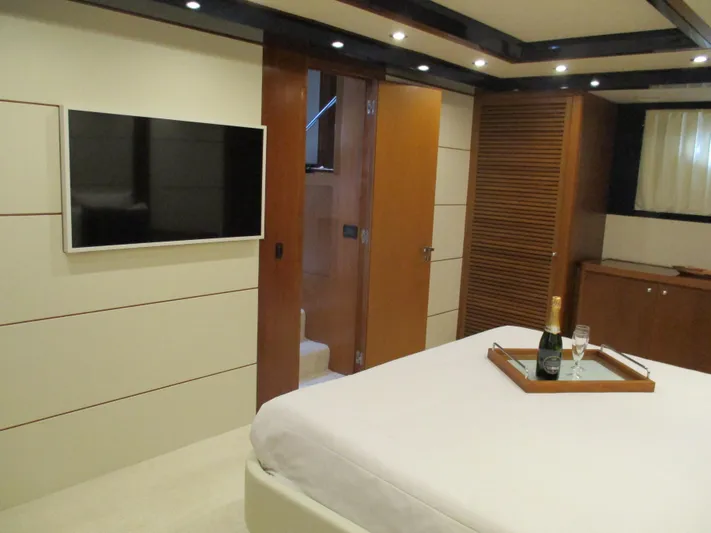 Mr Chic Yacht Photos Pics Luxurious bedroom in 2001 Riva 84 Cantata yacht with TV and champagne.