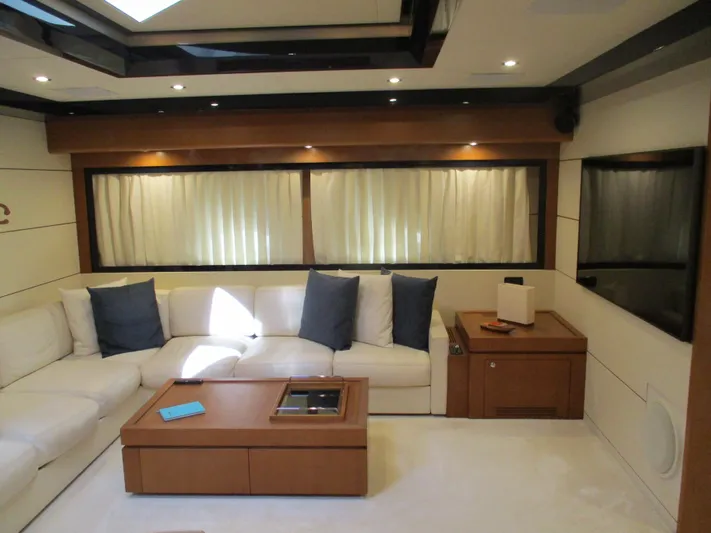 Mr Chic Yacht Photos Pics Luxurious interior of 2001 Riva 84 Cantata yacht with white seating and wooden accents.