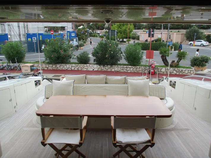 Mr Chic Yacht Photos Pics Outdoor seating area on 2001 Riva 84 Cantata yacht with table and chairs.