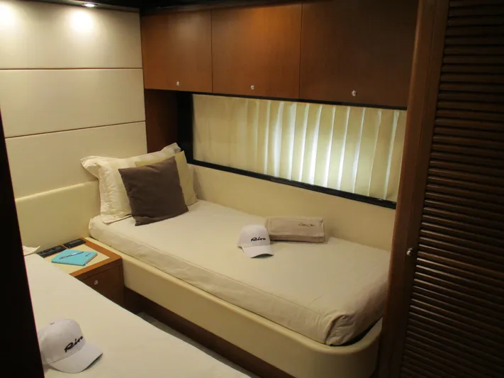 Mr Chic Yacht Photos Pics Luxurious cabin interior of 2001 Riva 84 Cantata yacht with cozy bed and elegant decor.