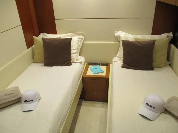 Mr Chic Yacht Photos Pics Twin beds in a 2001 Riva 84 Cantata yacht cabin with branded caps and pillows.