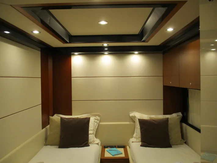Mr Chic Yacht Photos Pics Luxurious cabin interior of 2001 Riva 84 Cantata yacht with twin beds and modern lighting.