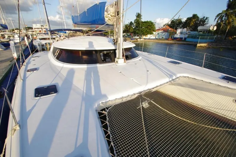  Yacht Photos Pics 2004 Fountaine Pajot Bahia 46 catamaran docked, featuring spacious deck and netting.