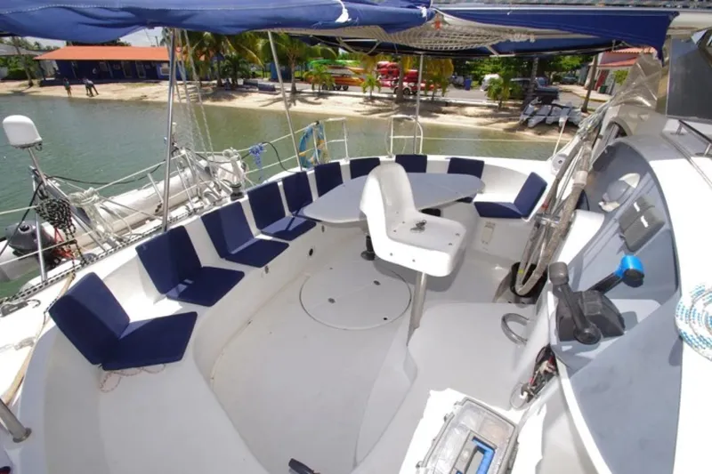  Yacht Photos Pics 2004 Fountaine Pajot Bahia 46 catamaran cockpit with seating, table, and helm station.