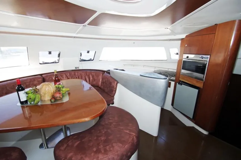  Yacht Photos Pics Interior of 2004 Fountaine Pajot Bahia 46 catamaran with dining area and kitchen.