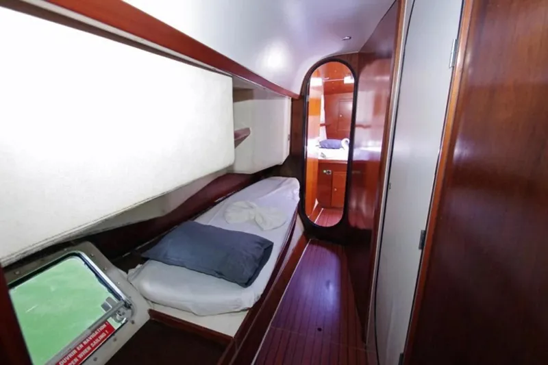  Yacht Photos Pics Interior cabin of 2004 Fountaine Pajot Bahia 46 catamaran, featuring cozy sleeping quarters.