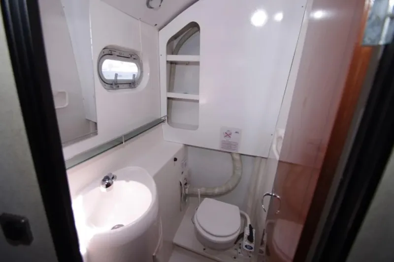  Yacht Photos Pics Bathroom interior of 2004 Fountaine Pajot Bahia 46 catamaran, featuring sink and toilet.