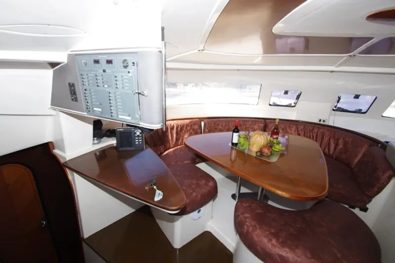  Yacht Photos Pics Interior of 2004 Fountaine Pajot Bahia 46 catamaran with dining area and control panel.