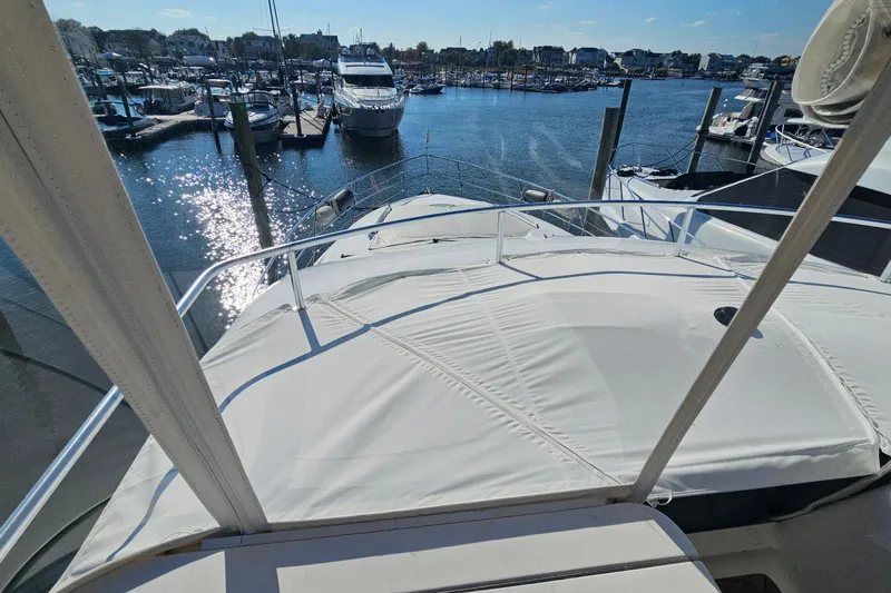 Dream Team Xiii Yacht Photos Pics 2005 Neptunus 56 Flybridge yacht docked at a marina under sunny skies.