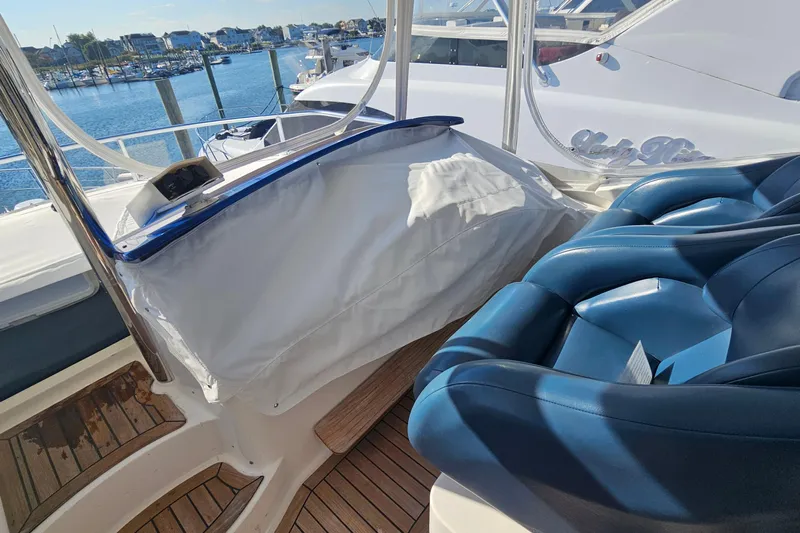 Dream Team Xiii Yacht Photos Pics Flybridge of 2005 Neptunus 56 yacht with blue seating and marina view.