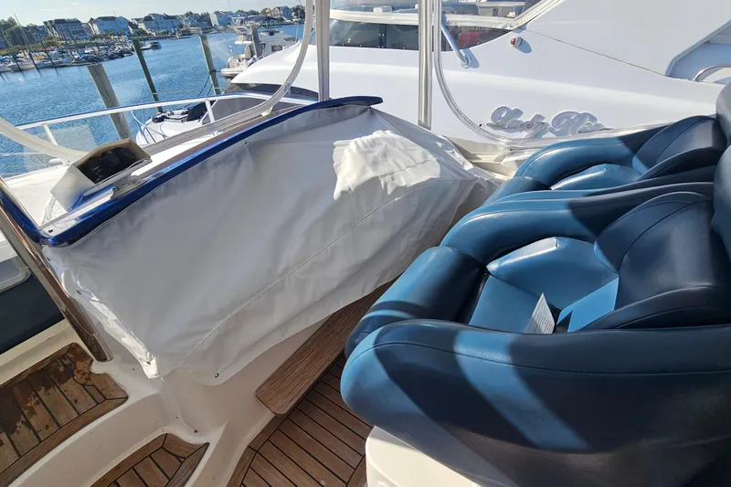 Dream Team Xiii Yacht Photos Pics 2005 Neptunus 56 Flybridge yacht interior with blue leather seating and marina view.