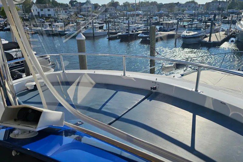 Dream Team Xiii Yacht Photos Pics 2005 Neptunus 56 Flybridge yacht docked at a marina with scenic waterfront views.