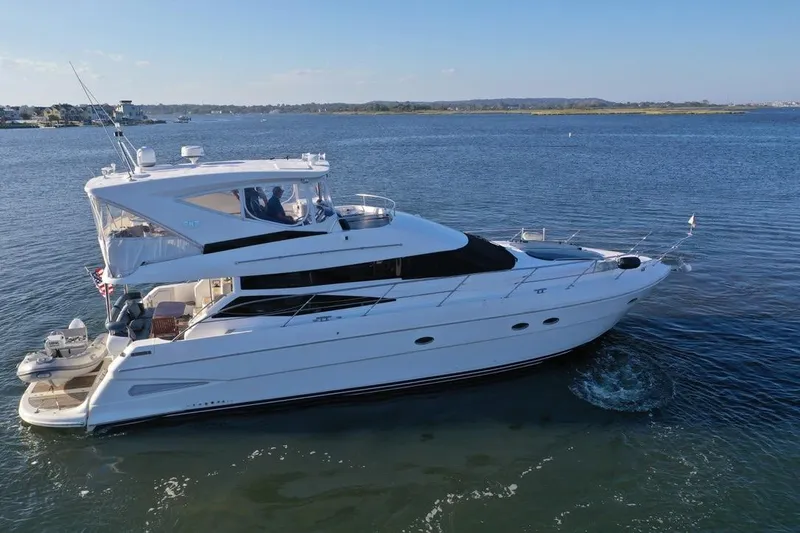 Dream Team Xiii Yacht Photos Pics 2005 Neptunus 56 Flybridge yacht cruising on calm waters under clear skies.