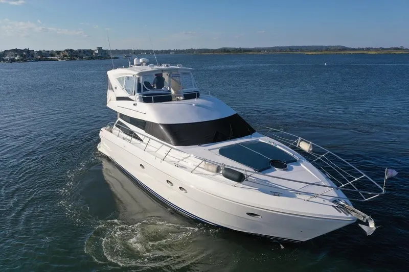 Dream Team Xiii Yacht Photos Pics 2005 Neptunus 56 Flybridge yacht cruising on calm waters.