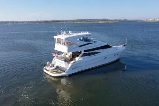 Dream Team Xiii Yacht Photos Pics 2005 Neptunus 56 Flybridge yacht cruising on calm waters.