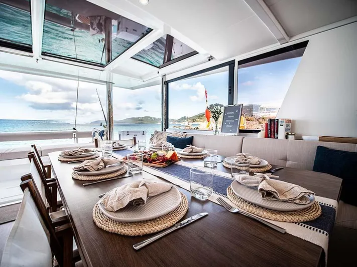 Cocktails And Dreams Yacht Photos Pics Luxurious dining setup on 2022 Bali 5.4 yacht with ocean view.